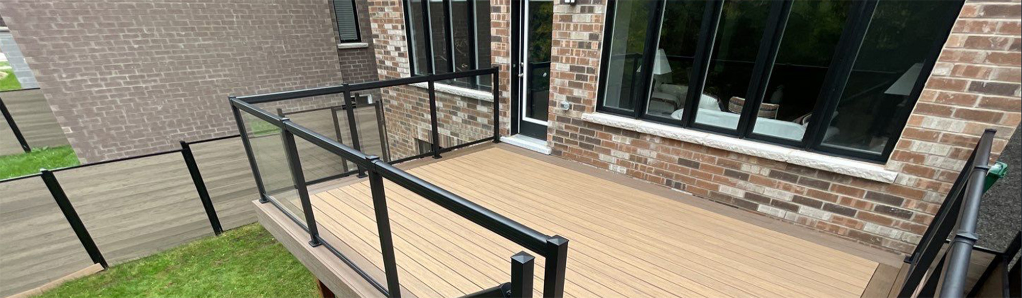 wooden deck with black metal railings
